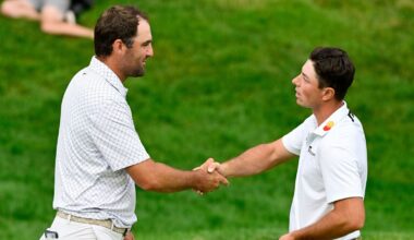 Scottie Scheffler shakes hands with Viktor Hovland on the 18th green after finishing the third round. (AP Photo/Jessica Hill)