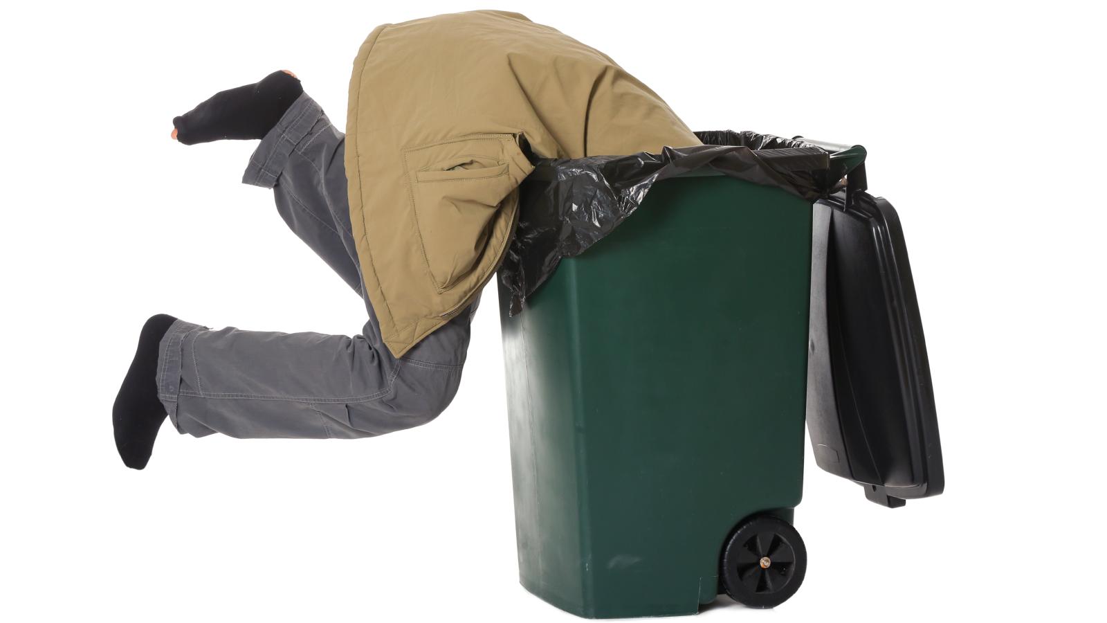 man in a trash can