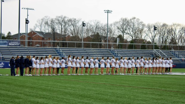The University of Connecticut women's lacrosse team observing a moment of silence for Morgan Rodgers at the Morgan's Message dedication game on April 1 at Joseph J. Morrone Stadium in Storrs. (Sydney Haywood)