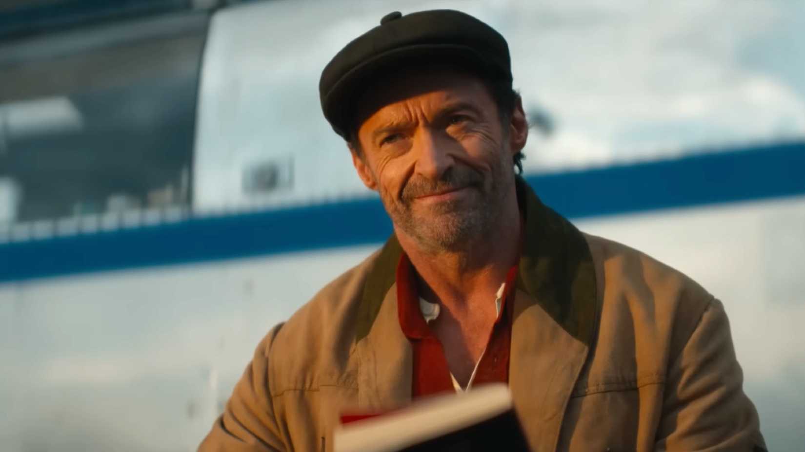 The Sheep Detectives screenshot showing Hugh Jackman looking satisfied while holding a book