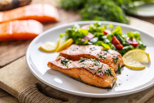 Two salmon fillets baked until crispy with parsley