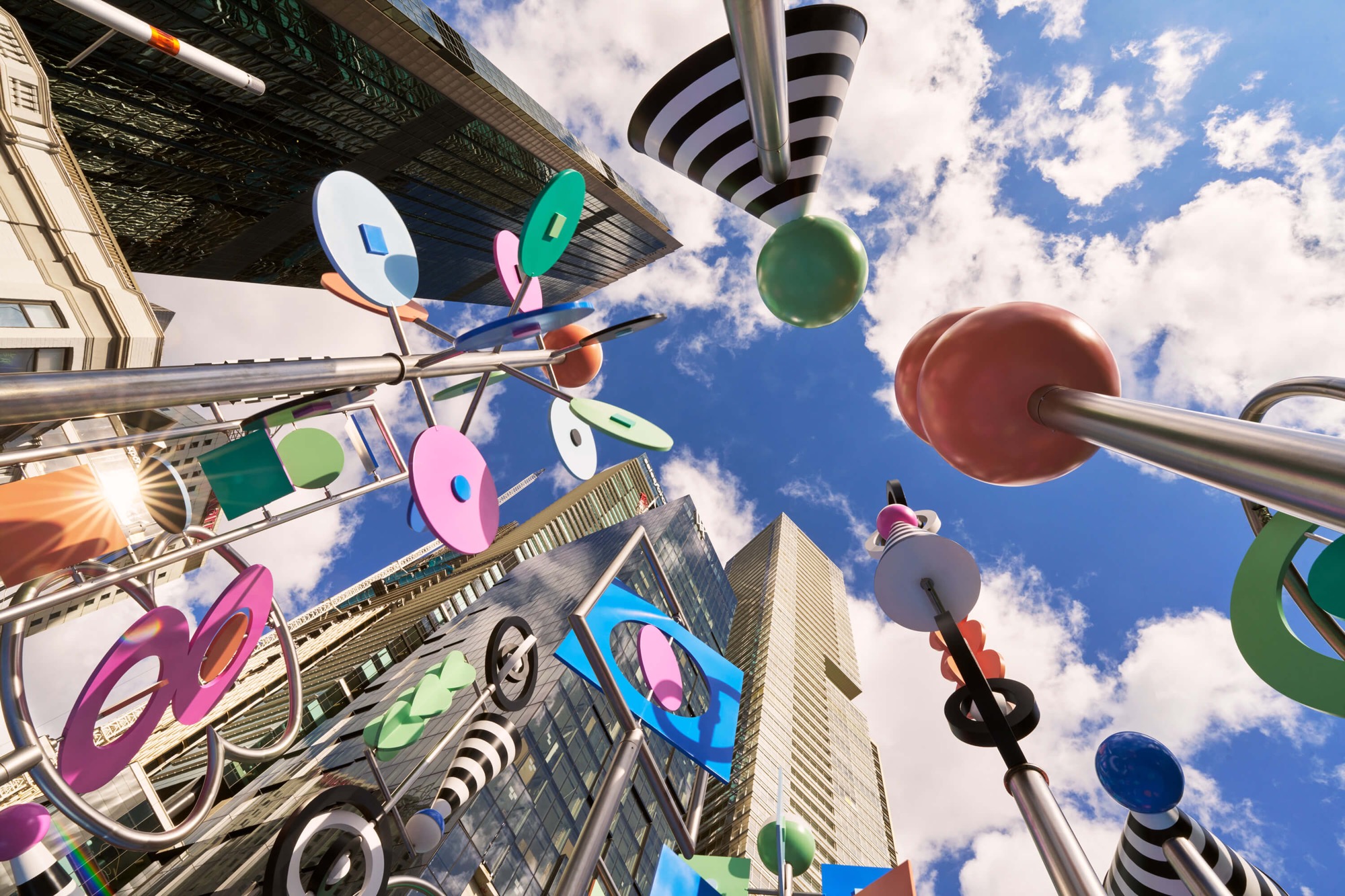 a detail photo of a colorful outdoor sculpture with twirling shapes by Wade and Leta