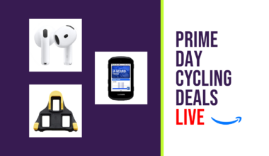 Prime Day Live report hero image, comprising a purple and white background with three products from the sales: a pair of airpods, a shimano shoe cleat, and a garmin computer