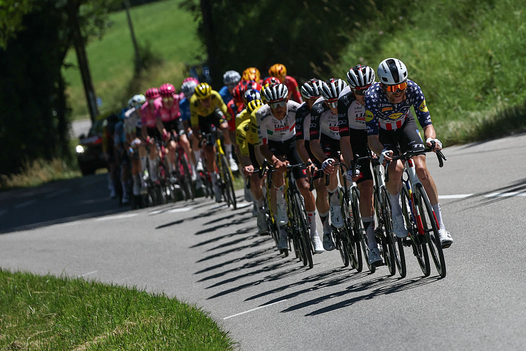 Lidl-Trek's US rider Quinn Simmons cycles ahead of the pack of riders (peloton) during the 7th stage of the Tour Auvergne-Rhone-Alpes cycling race (formerly known as the Criterium du Dauphine), 133,6km between La Bridoire and Grand Colombier in the French Alps on June 13, 2026. (Photo by Anne-Christine POUJOULAT / AFP)