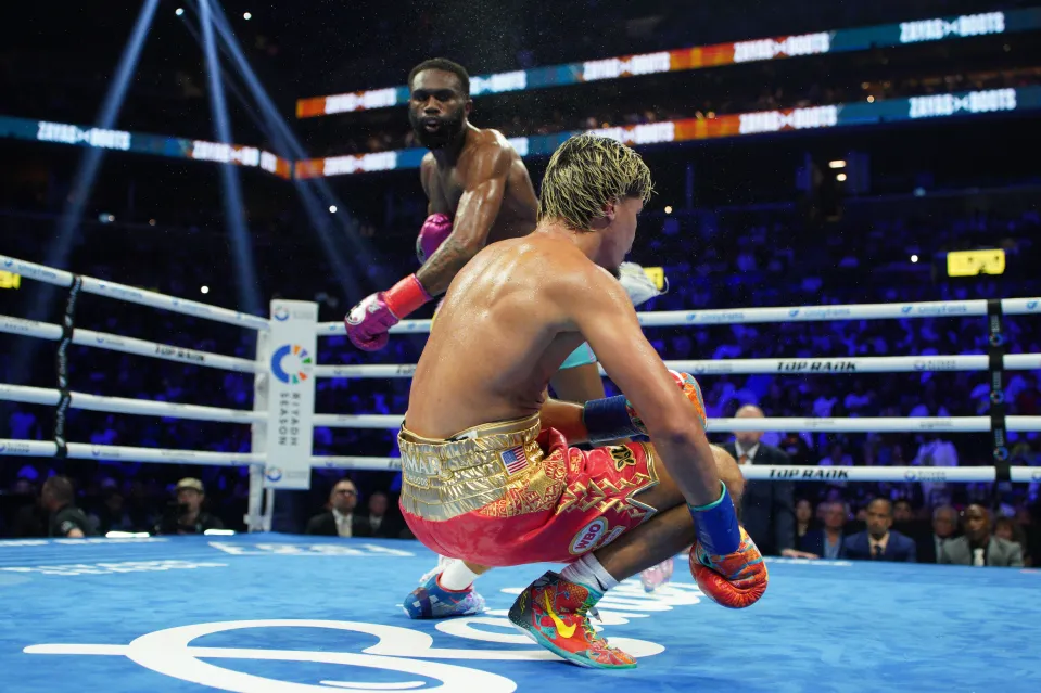 Xander Zayas is knocked down by Jaron 'Boots' Ennis during their WBO and WBA World Super-Welterweight title bout at Barclays Center on June 27, 2026 in New York City