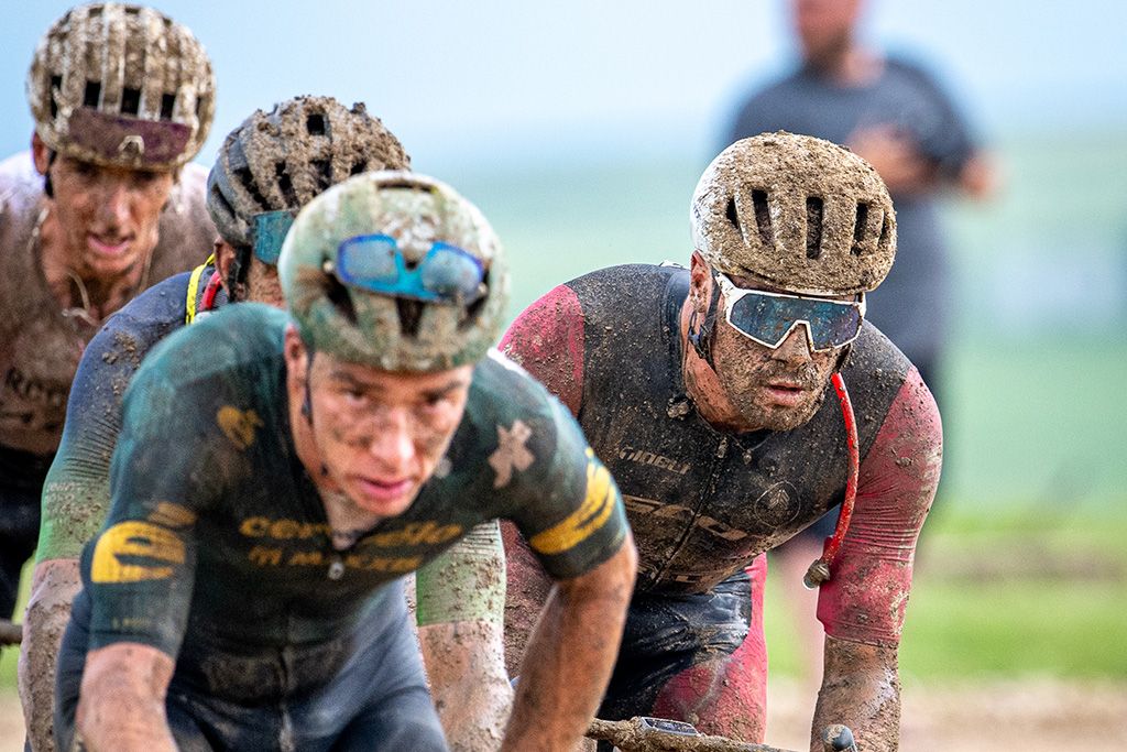 Matthew Wilson (right) riding in a group during the mud of Unbound 200 2026