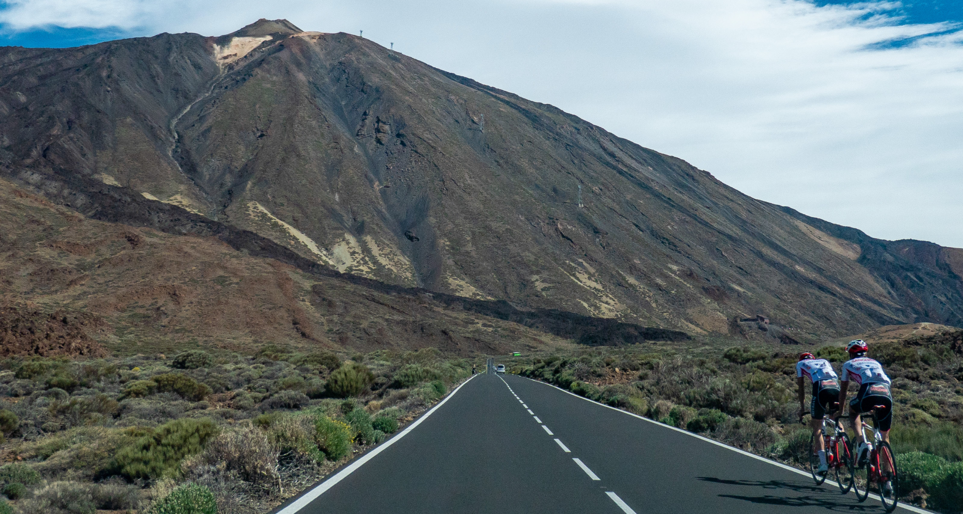 Cyclists on a road cycling during a blue sky summer day around the volcanic landscape of El Teide Volcano and National Park (Photo by Nicolas Economou/NurPhoto via Getty Images)