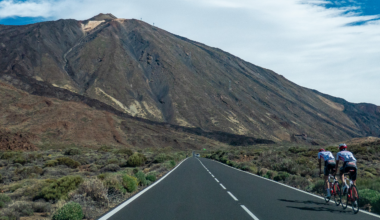 Cyclists on a road cycling during a blue sky summer day around the volcanic landscape of El Teide Volcano and National Park (Photo by Nicolas Economou/NurPhoto via Getty Images)