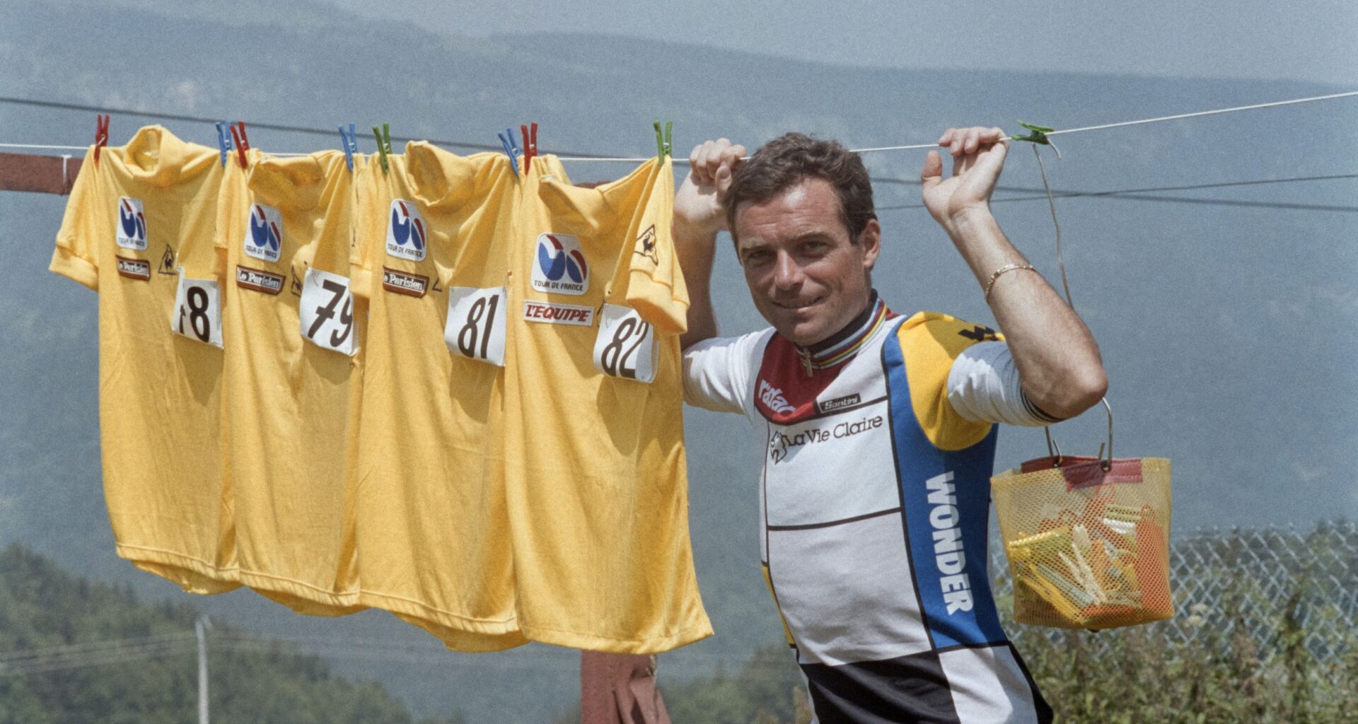 Bernard Hinault poses with four yellow jerseys