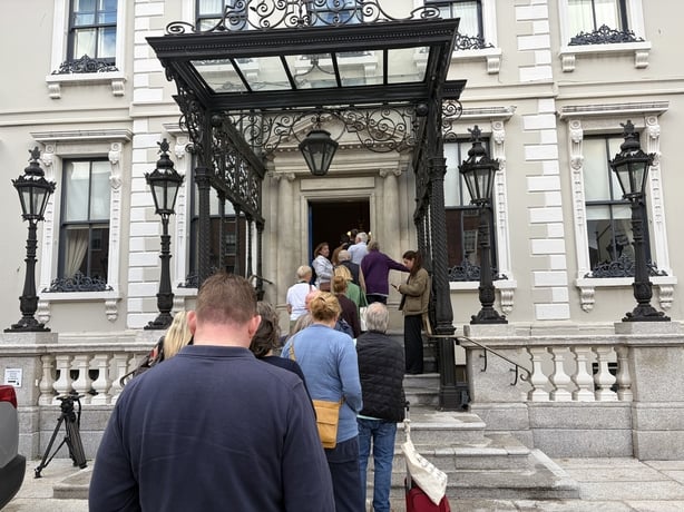 Members of the public queue up to sign the book of condolence for Glen Hansard at the Mansion House in Dublin. Photo: Gráinne Ní Aodha/PA Wire