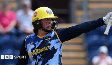 Lauren Parfitt of Glamorgan raises her bat to celebrate her fifty