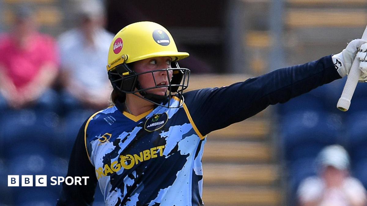 Lauren Parfitt of Glamorgan raises her bat to celebrate her fifty