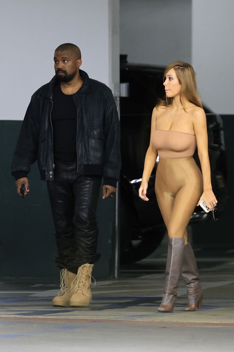 Bianca Censori returned to her signature "second-skin" style in a skintight strapless bodysuit during a Los Angeles outing with Kanye West.