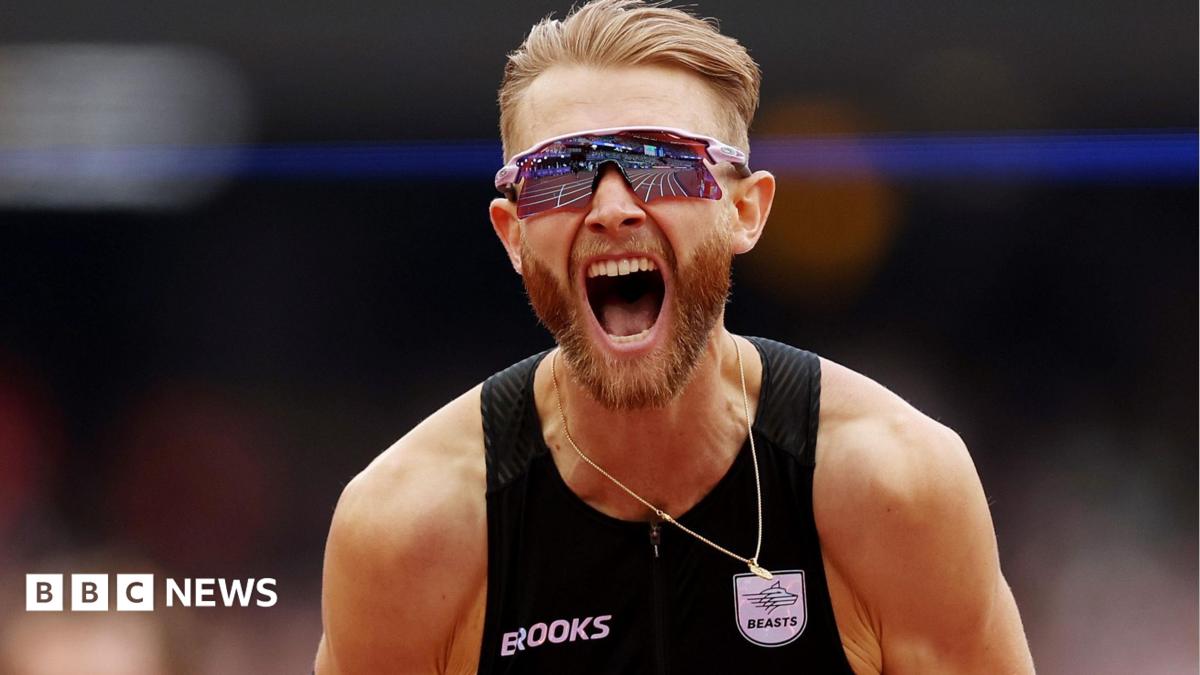 Josh Kerr roars with delighted after breaking the mile record. he has blonde hair and a beared and is wearing a black running vester and reflective wraparound sunglasses.