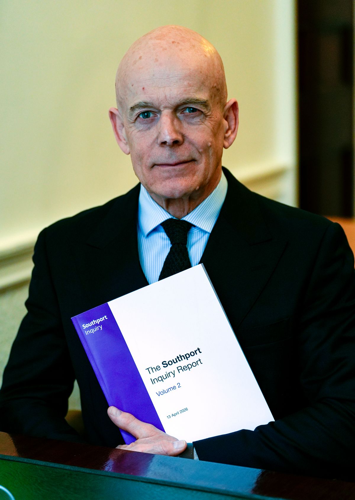 Chair Sir Adrian Fulford sitting inside the hearing room at Liverpool Town Hall following the release of the Southport Inquiry phase one report