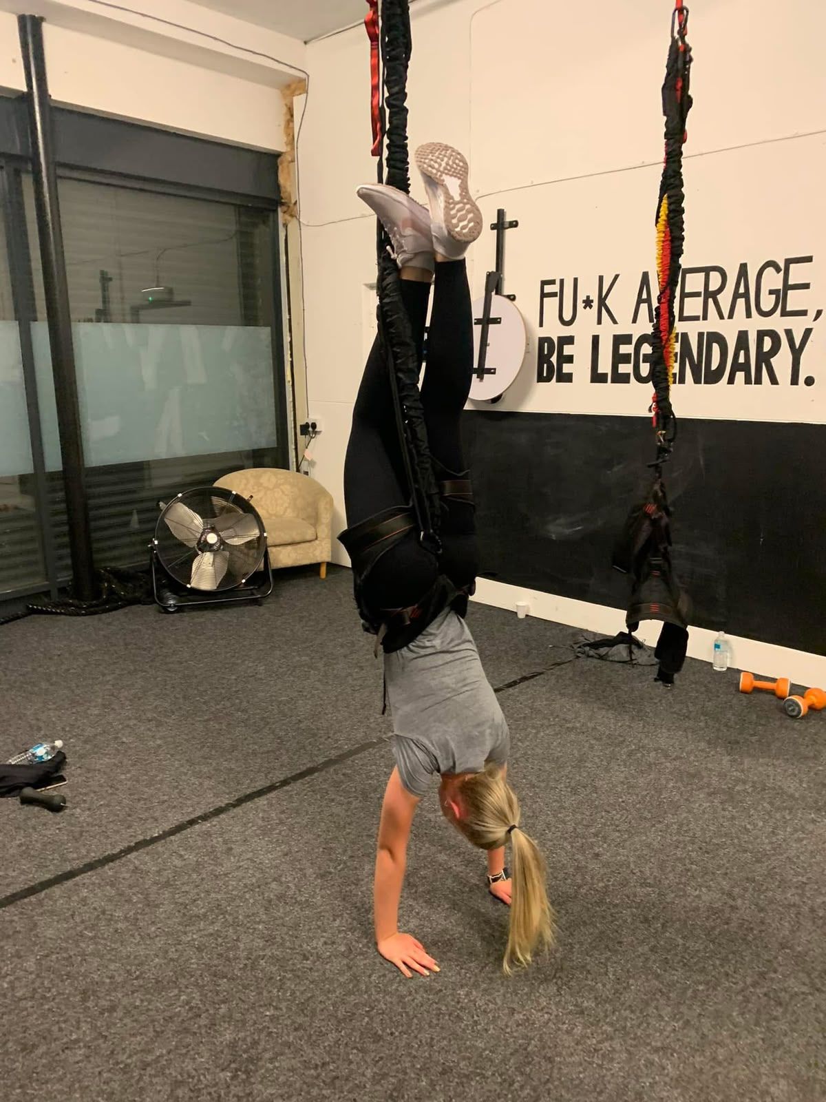 Olivia upside down in her bungee fitness class