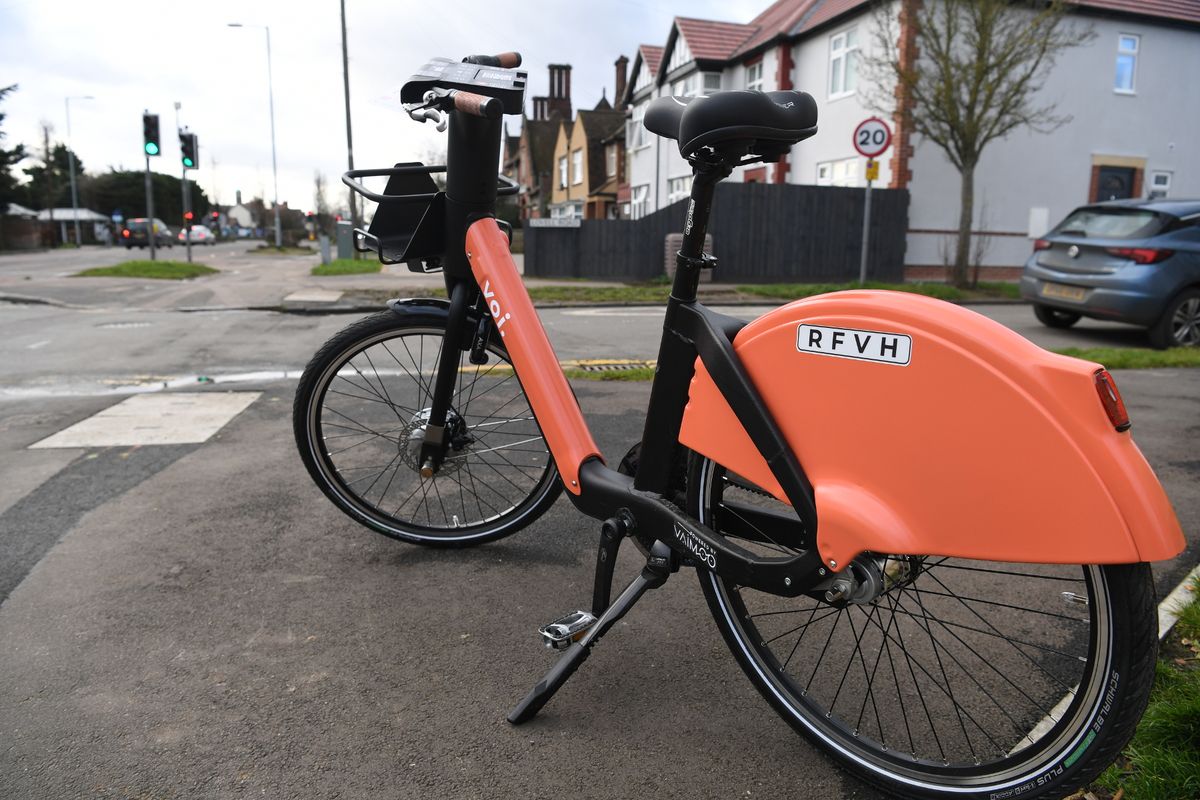 A voi e-bike parked on the pavement