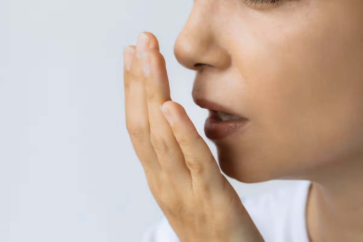 woman smelling her breath
