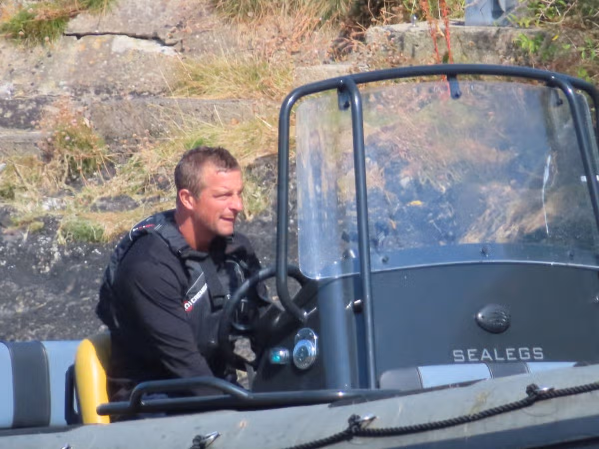 Bear Grylls was spotted collecting his Waitrose shopping in a custom-built boat with wheels on the mainland opposite his private Welsh island.