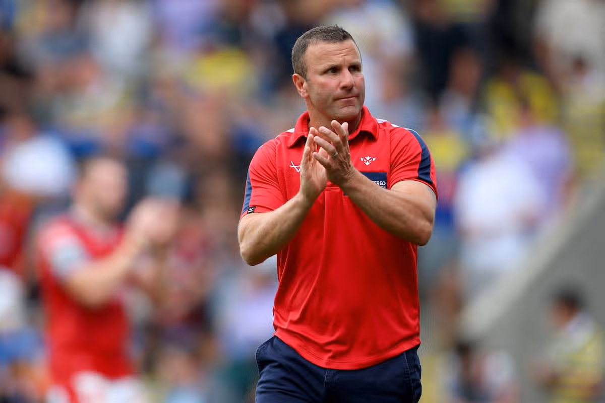 Hull KR head coach Willie Peters applauds the fans after the match at Warrington