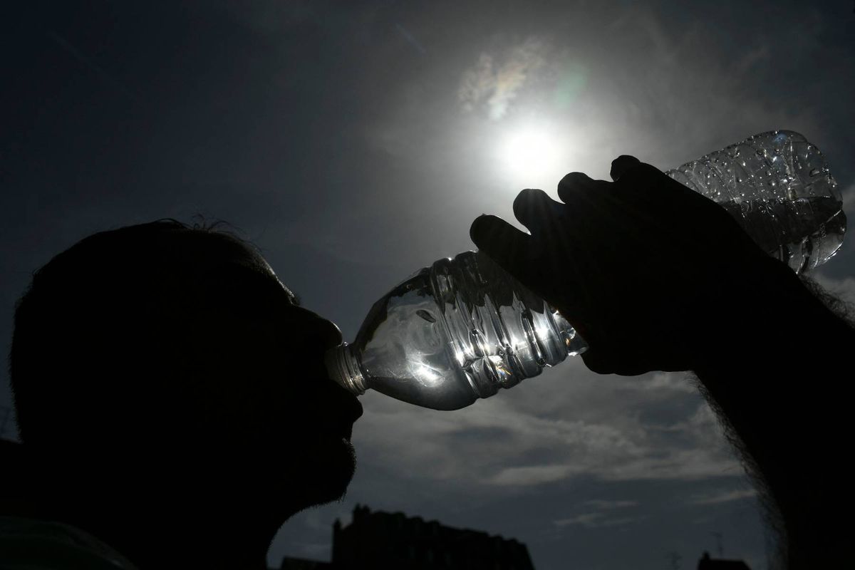 A person drinking a bottle of water