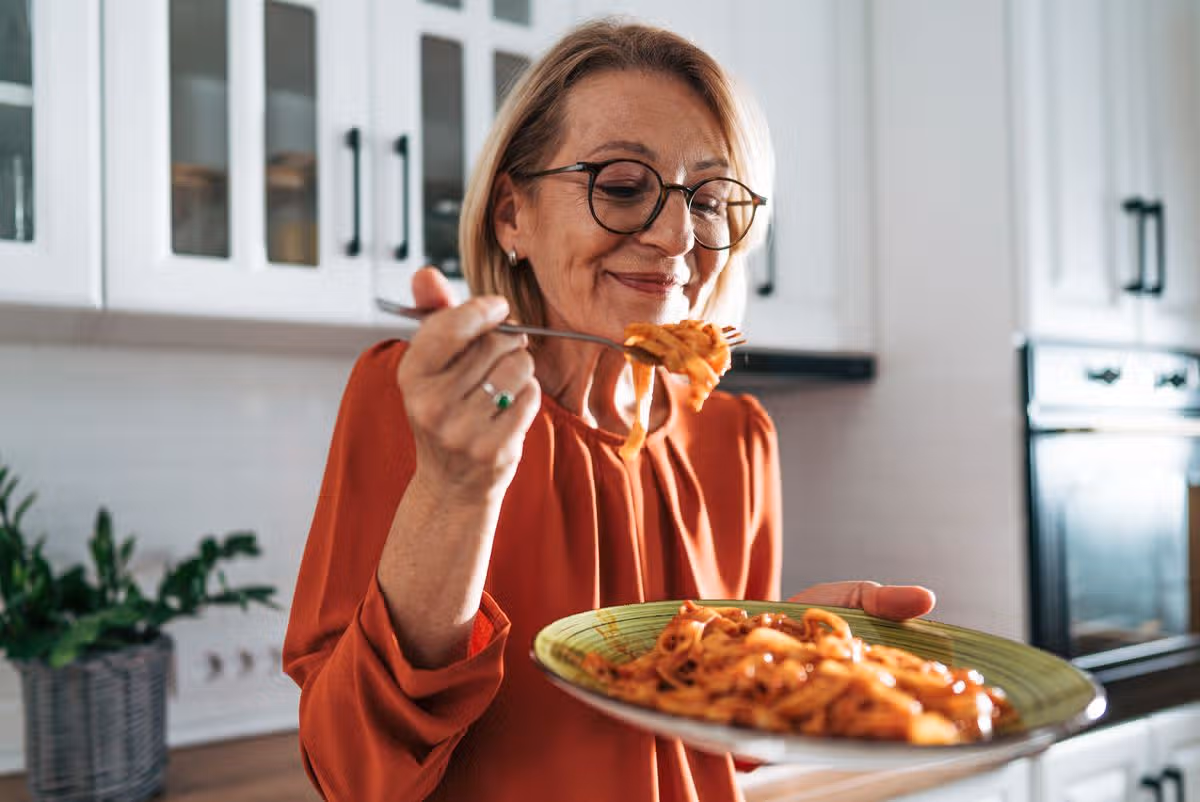 Woman eating pasta