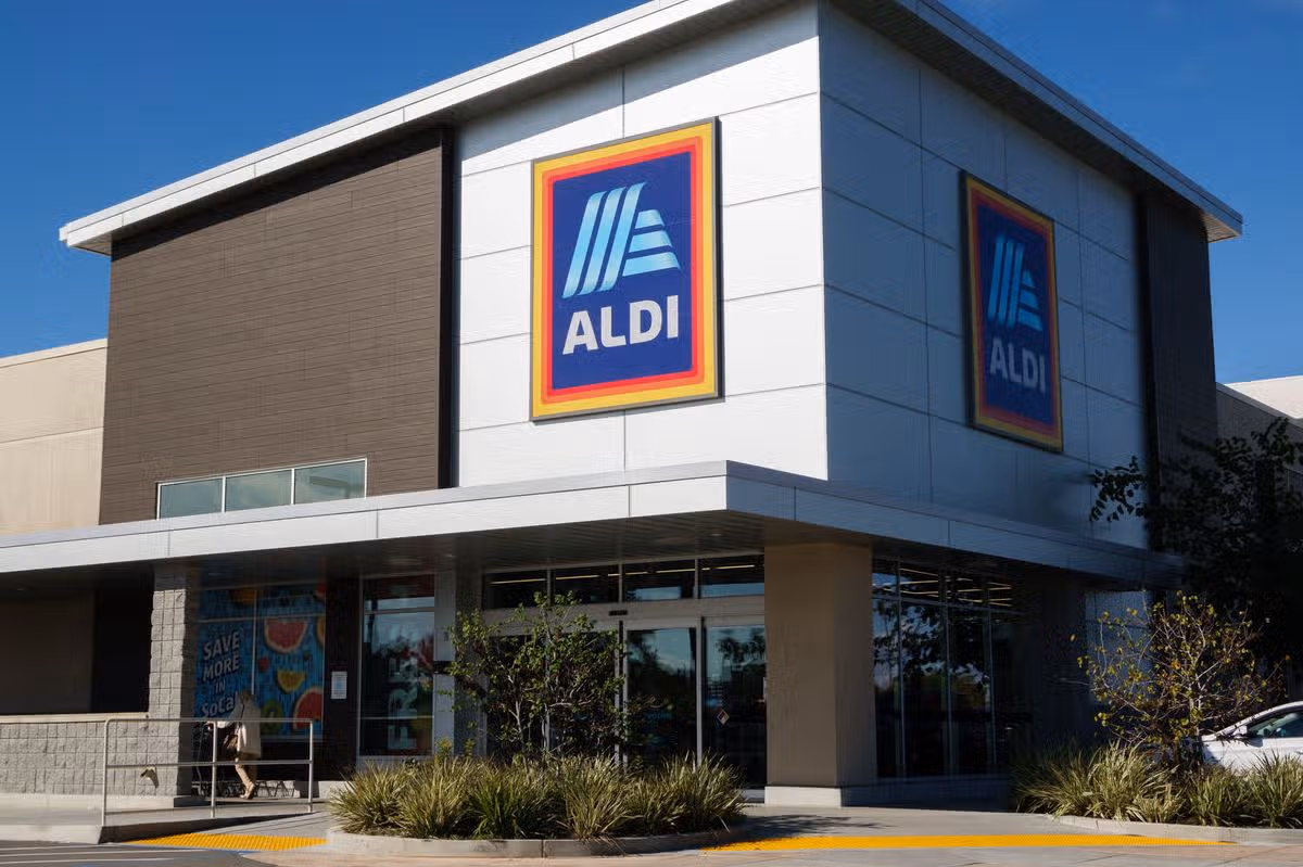 An Aldi logo is displayed on a sign outside of a market