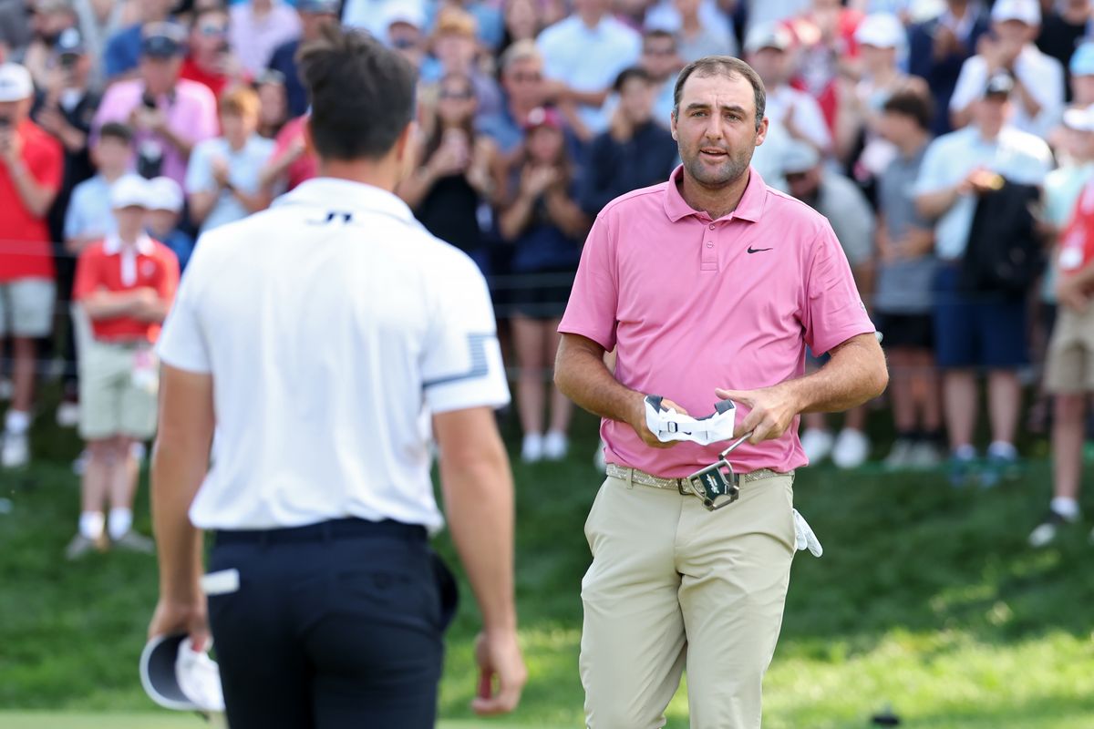 Viktor Hovland of Norway (L) and Scottie Scheffler of the United States shake hands on the 18th green after Hovland won the Travelers Championship 2026