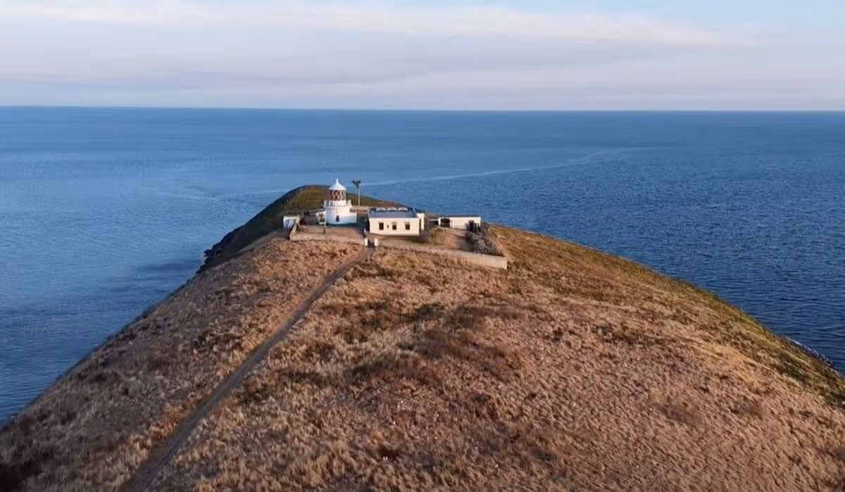 Snips taken from Facebook video on Bear Grylls account of drone shots of Saint Tudwal Island West off the coast at Abersoch that he owns - The drone footage pans out to reveal the Grade II listed lighthouse and former keeper's cottage in an aerial shot
