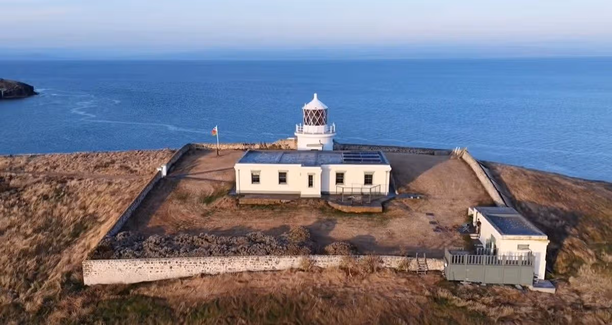 Snips taken from Facebook video on Bear Grylls account of drone shots of Saint Tudwal Island West off the coast at Abersoch that he owns - The drone footage pans out to reveal the Grade II listed lighthouse and former keeper's cottage in an aerial shot
