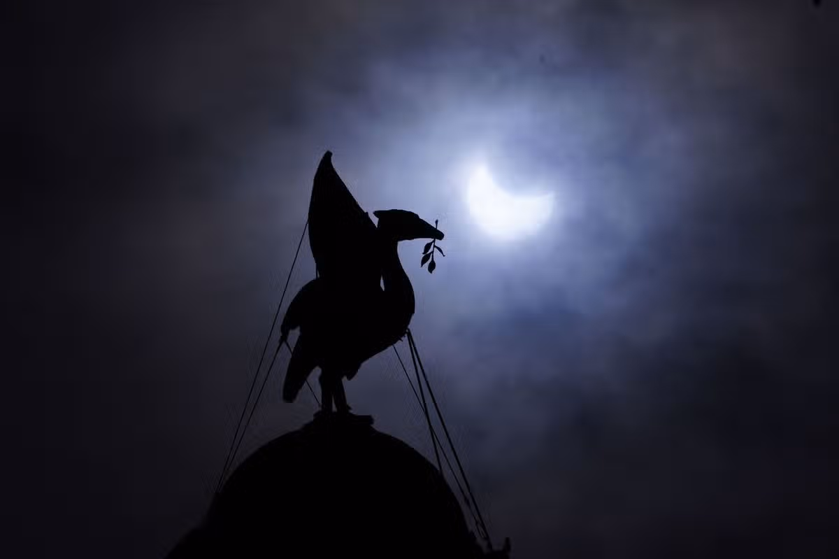 The partial solar eclipse as seen over The Royal Liver Building on Liverpool's waterfront