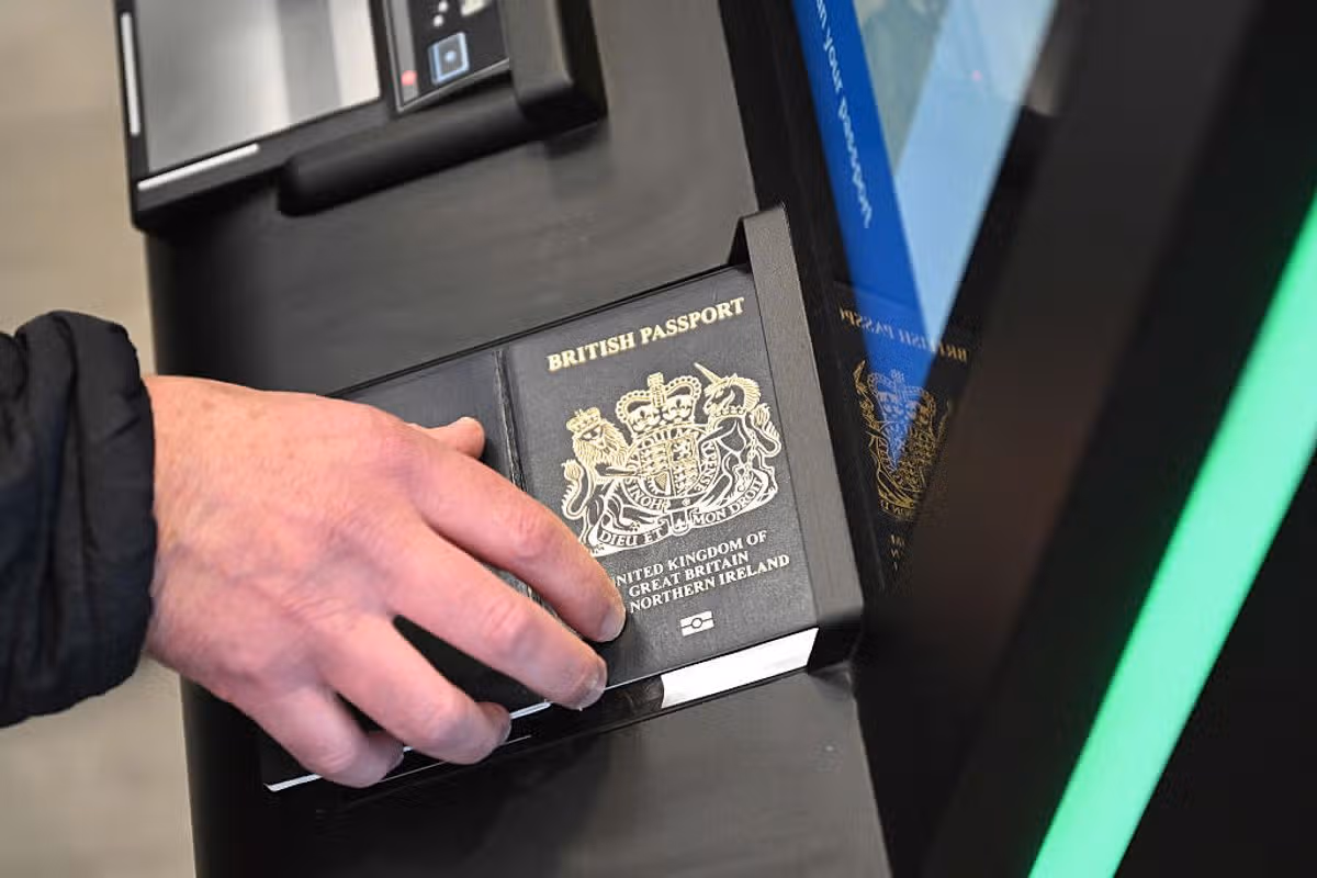 A person as their passport scanned whilst using an Automated European Union Entry/Exit System (EES) kiosk