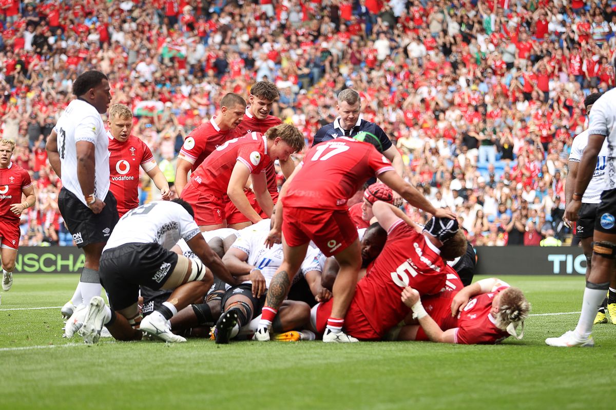 Aaron Wainwright of Wales gets over the line to score a try
