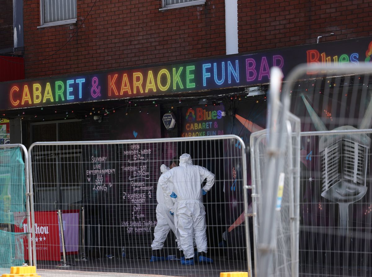 Forensic officers outside the bar in Ashton