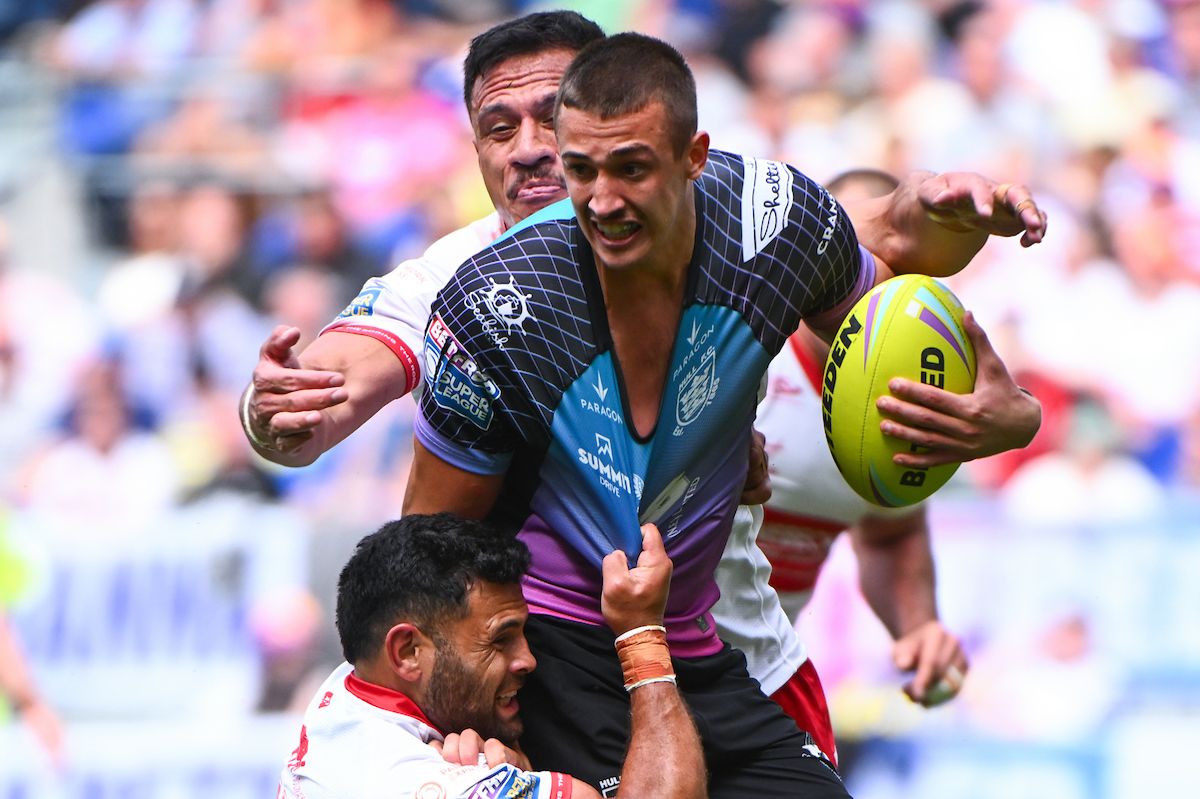 Jake Arthur of Hull FC is tackled by Rhyse Martin of Hull KR