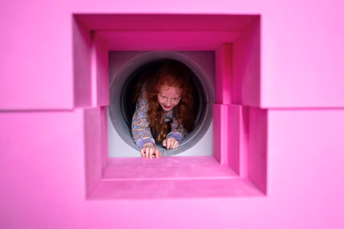 Children playing with the Playshapes installation