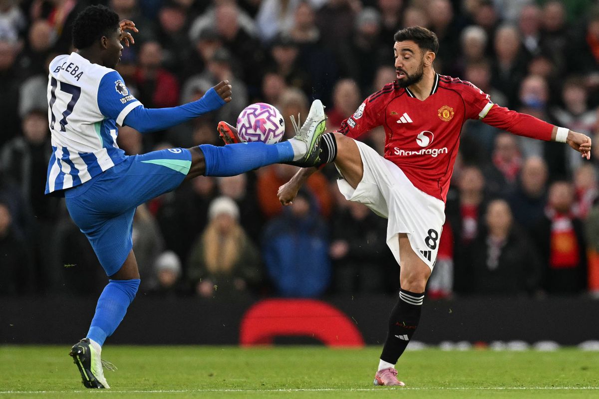Manchester United's Portuguese midfielder #08 Bruno Fernandes (R) and Brighton's Cameroonian midfielder #17 Carlos Baleba (L) battle for the ball during the English Premier League football match between Manchester United and Brighton and Hove Albion at Old Trafford