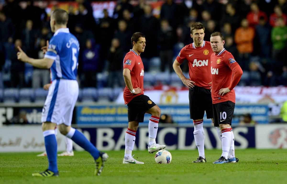 Javier Hernandez, Michael Carrick and Wayne Rooney wait to kick off after Wigan's goal during the Barclays Premier League match between Wigan Athletic and Manchester United at DW Stadium