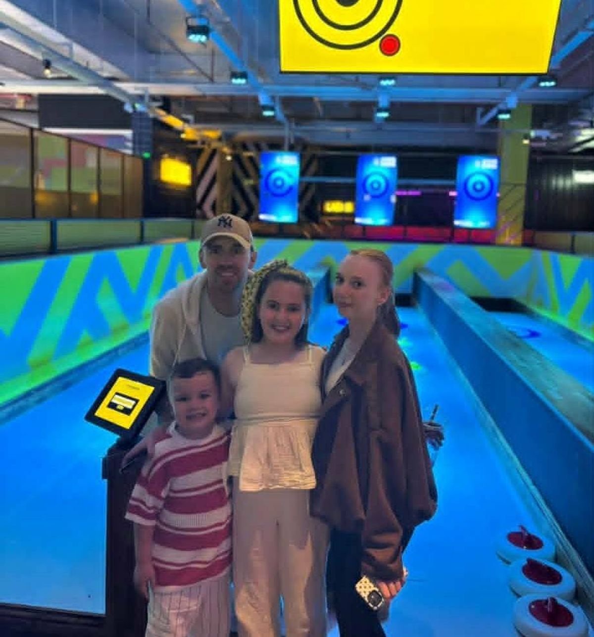 John with his three kids at bowling alley