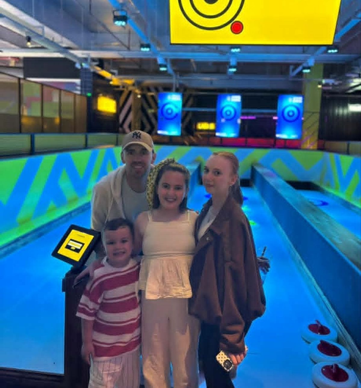 John with his three kids at bowling alley