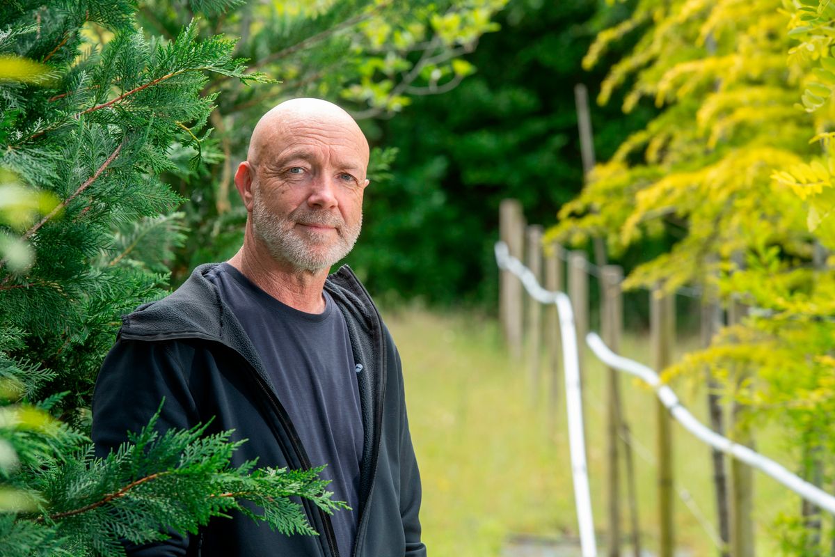 owner Gary Jones standing amongst trees at the Dutch Garden centre, Cardiff, which is closing after 50 years. 