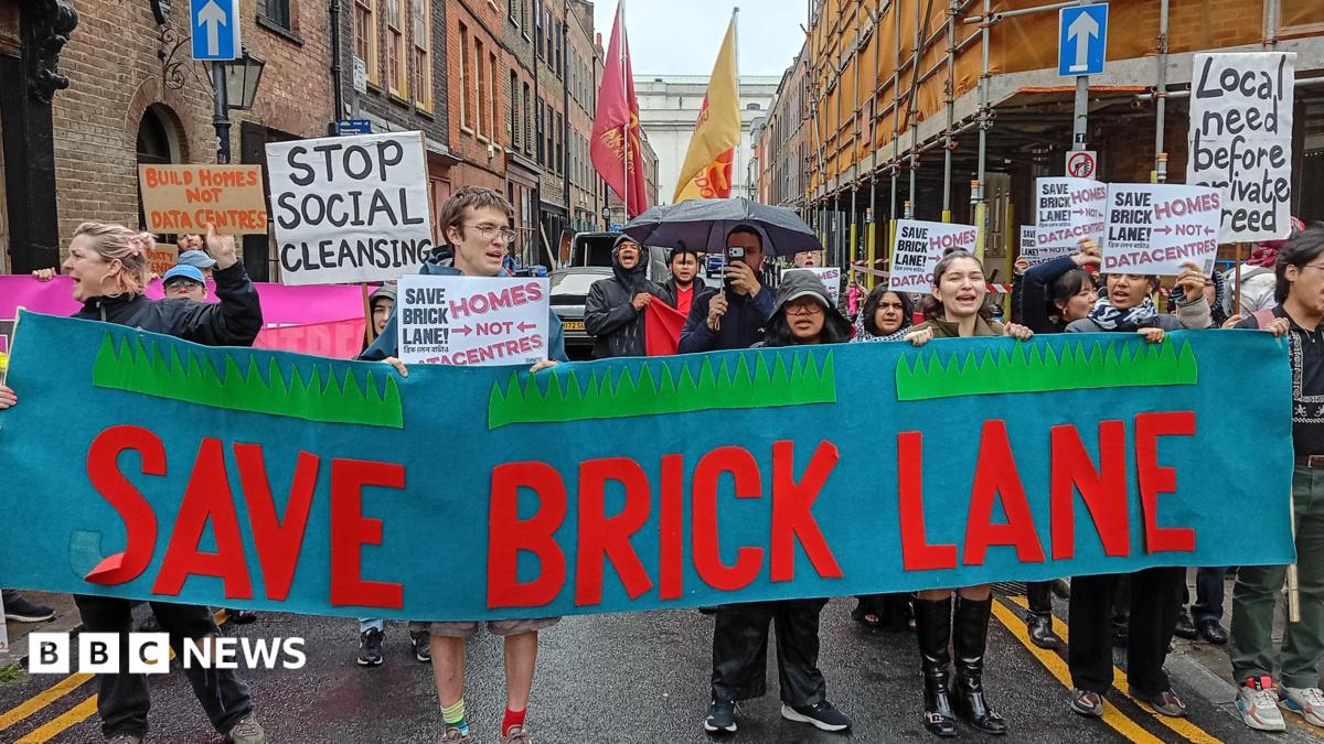 Campaigners march through Brick Lane carrying a large "Save Brick Lane" banner and placards opposing plans for data centres and calling for more homes.