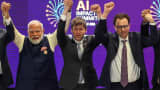 India Prime Minister Narendra Modi, left, with OpenAI CEO Sam Altman, center, and Anthropic CEO Dario Amodei at the AI Impact Summit in New Delhi on Feb. 19, 2026.
