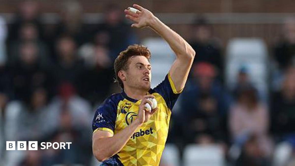 Kasey Aldridge bowling for Durham in the T20 Blast with his right hand holding the white ball and his left hand raised high for leverage