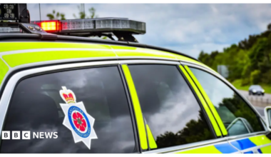 Library image of a Lancashire Constabulary police car, marked in fluorescent yellow and blue checks.