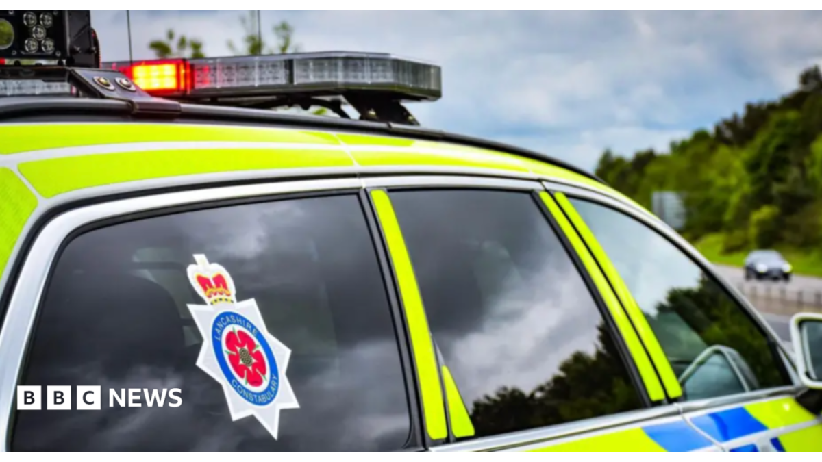 Library image of a Lancashire Constabulary police car, marked in fluorescent yellow and blue checks.