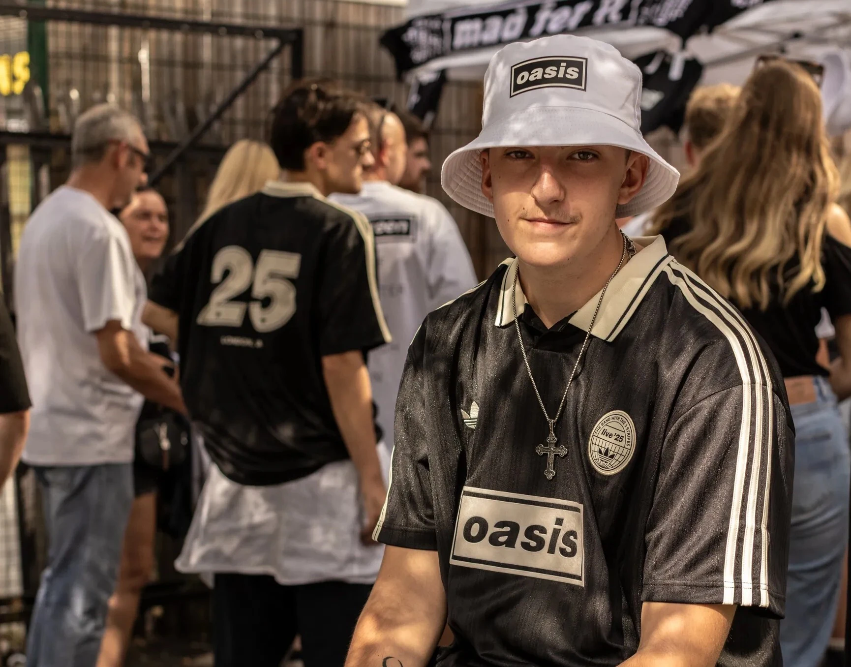Oasis fan outside merch stall at Wembley Stadium 