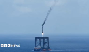 A screengrab of  a Long March 10B booster rocket landing on a recovery platform.