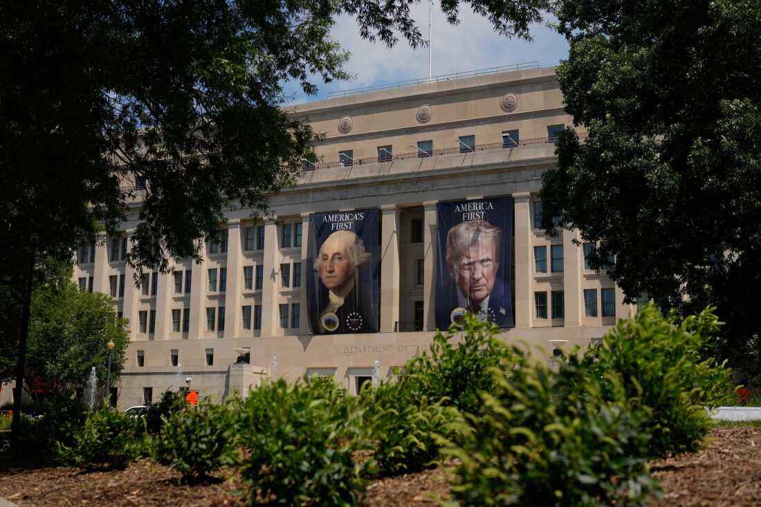 Banners of former President George Washington and President Donald Trump hang above an entrance to the Department of the Interior, Thursday, June 25, 2026, in Washington.