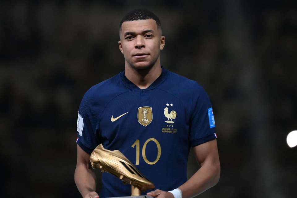TOPSHOT - France's forward #10 Kylian Mbappe poses after receiving the Golden Boot award during the Qatar 2022 World Cup trophy ceremony after the football final match between Argentina and France at Lusail Stadium in Lusail, north of Doha on December 18, 2022. - Argentina won in the penalty shoot-out. (Photo by FRANCK FIFE / AFP) (Photo by FRANCK FIFE/AFP via Getty Images)